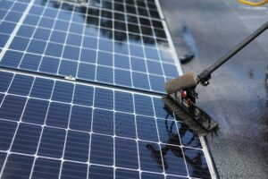 Solar Panel Cleaning with brush and panel-friendly solution.
